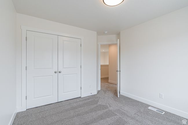 Unfurnished bedroom featuring carpet and a closet | Image 12
