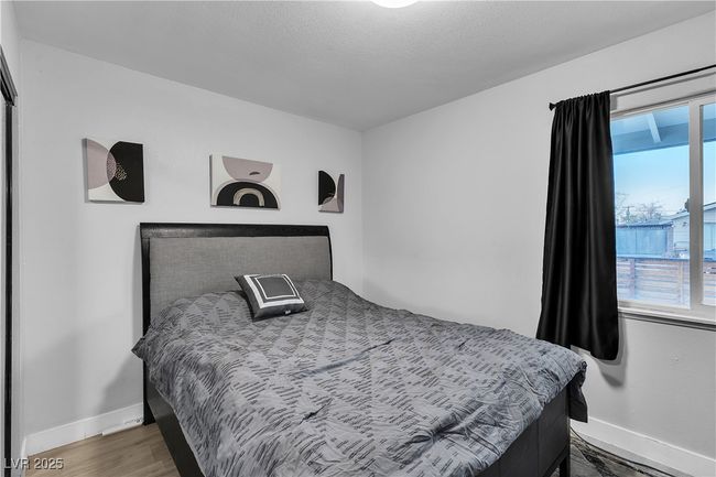 Bedroom with baseboards and wood finished floors | Image 30