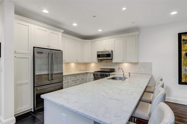 Kitchen with stainless steel appliances, a sink, , and recessed lighting | Image 9