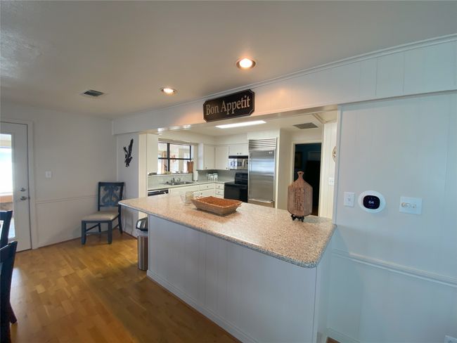 Kitchen view from living room. Room for 3 bar stools | Image 9