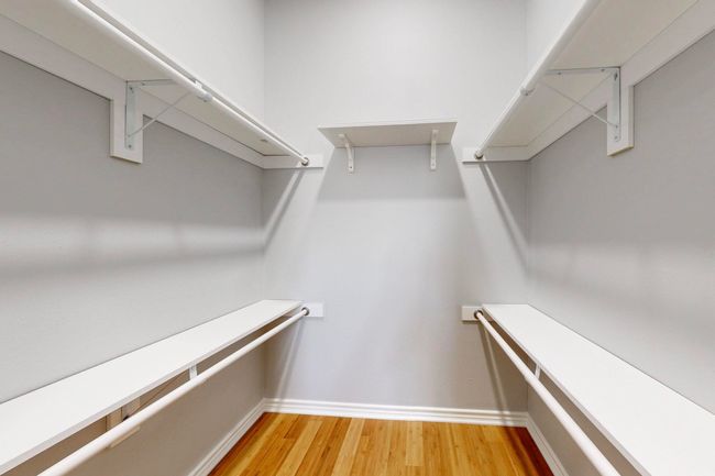 Spacious closet with light wood-style floors | Image 15