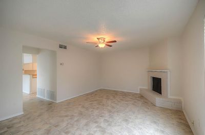 538 - Living Room with ceiling fan and wood burning fireplace, ceramic tile | Image 2