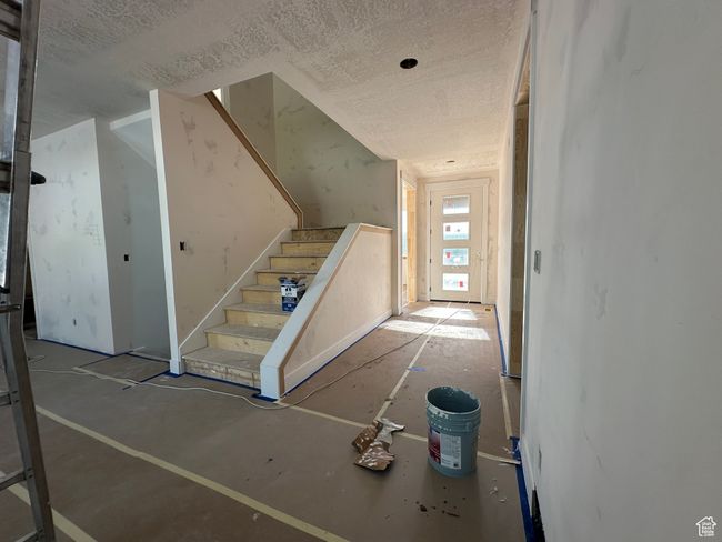 Stairs featuring a textured ceiling | Image 12