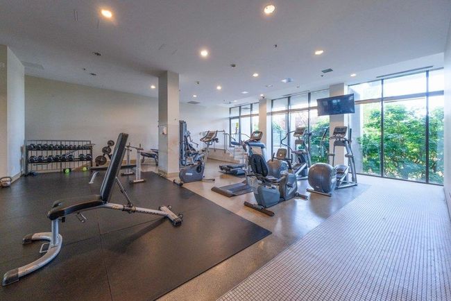 Exercise room with expansive windows and recessed lighting | Image 23
