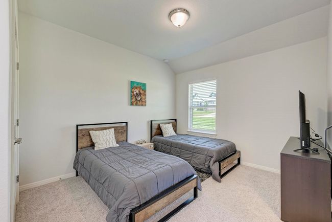 Another secondary bedroom sharing the Hollywood-style bath. This room has ample closet space and overlooks the side yard. | Image 33