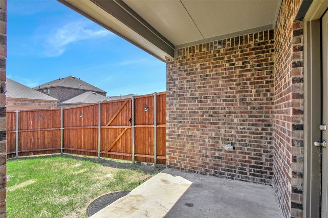 View of yard with a patio and a gate | Image 29