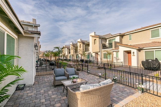 View of patio with outdoor lounge area, area for grilling, fence, and a residential view | Image 9