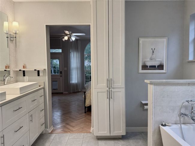 Full bath featuring a freestanding tub, ceiling fan, baseboards, and vanity | Image 23