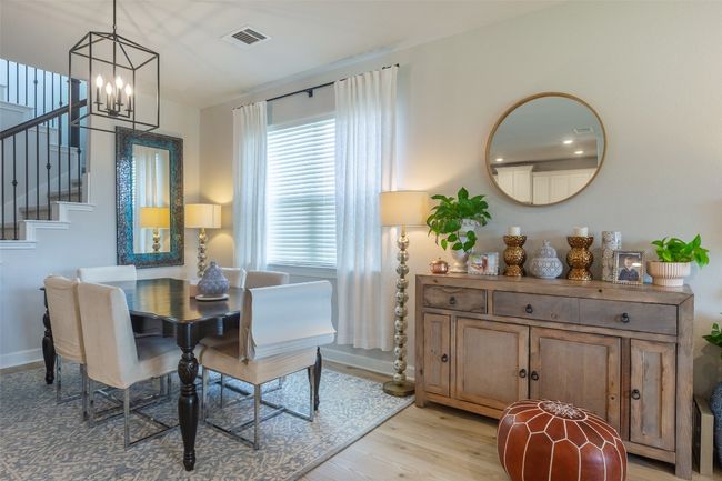 Dining room with a chandelier, light wood-style flooring, and stairway | Image 5