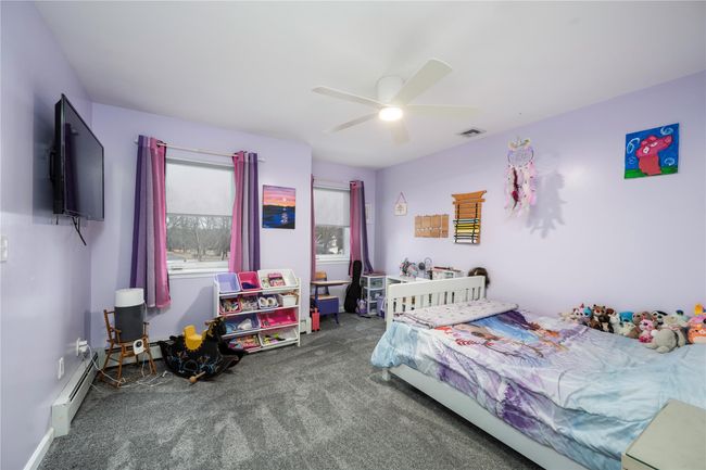 Carpeted bedroom with ceiling fan | Image 27