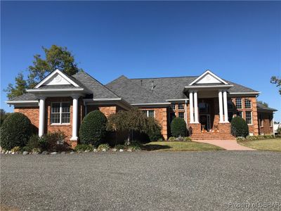 View of front of home with a front lawn and a water view | Image 1