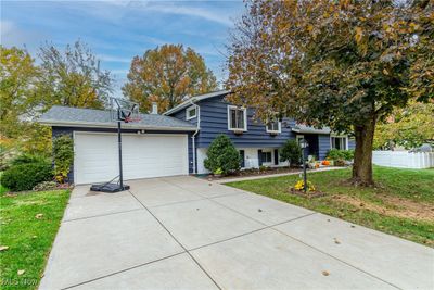 Tri-level home with a garage and a front lawn | Image 1