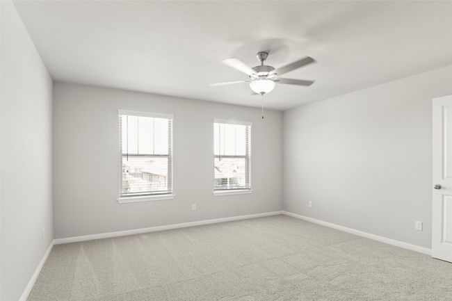Spare room featuring light colored carpet, a ceiling fan, and baseboards | Image 19