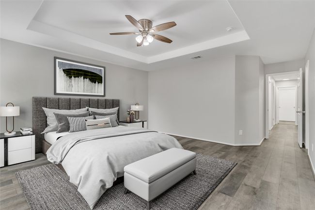 Bedroom featuring a raised ceiling, wood finished floors, baseboards, and a ceiling fan | Image 11