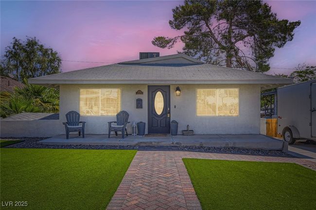 View of front of home featuring a yard and stucco siding | Image 25