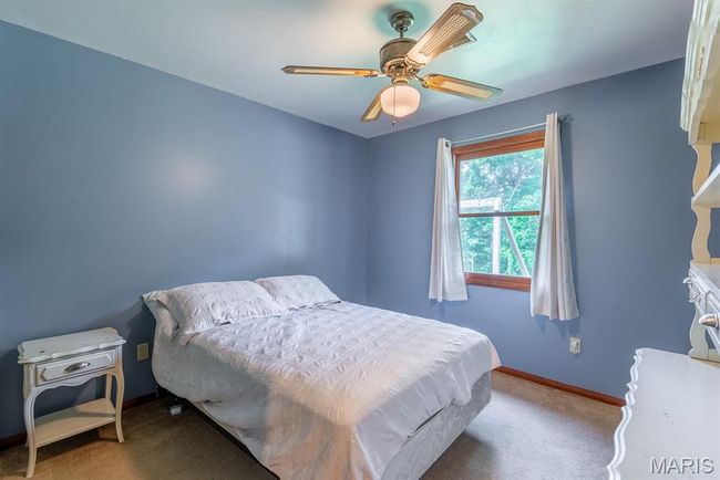 Bedroom with carpet flooring and ceiling fan | Image 18
