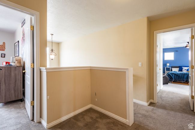 Corridor featuring carpet flooring, baseboards, and an upstairs landing | Image 21