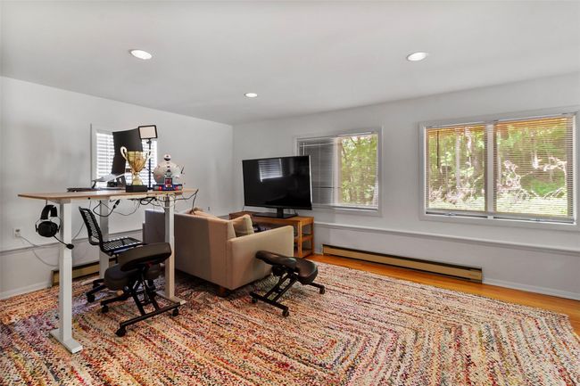 Living room with a baseboard radiator, wood finished floors, and recessed lighting | Image 17