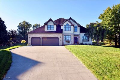 View of front of property featuring a garage and a front lawn | Image 1