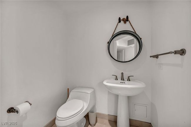 Half bathroom featuring baseboards, tile patterned flooring, and toilet | Image 15