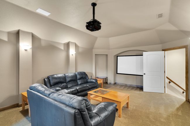 Media room with light carpet and vaulted ceiling | Image 34
