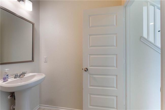Bathroom with a sink and baseboards | Image 19