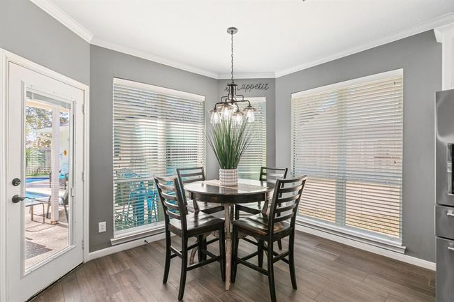 The breakfast area is located off the kitchen and can handle a crowd. It features a center fixture and views off the pool. | Image 22