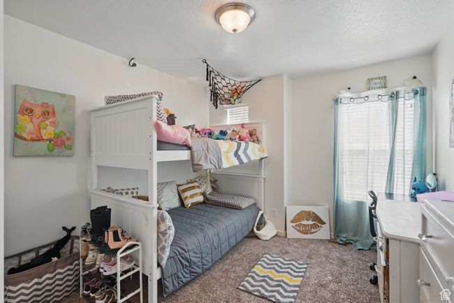 Carpeted bedroom with a textured ceiling | Image 28