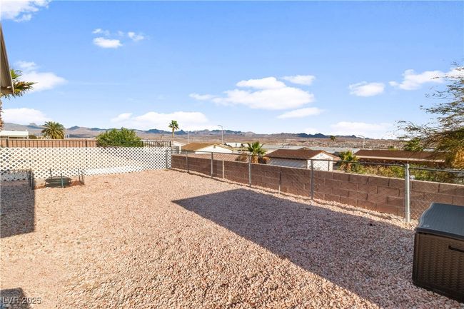 View of yard featuring a fenced backyard and a mountain view | Image 41