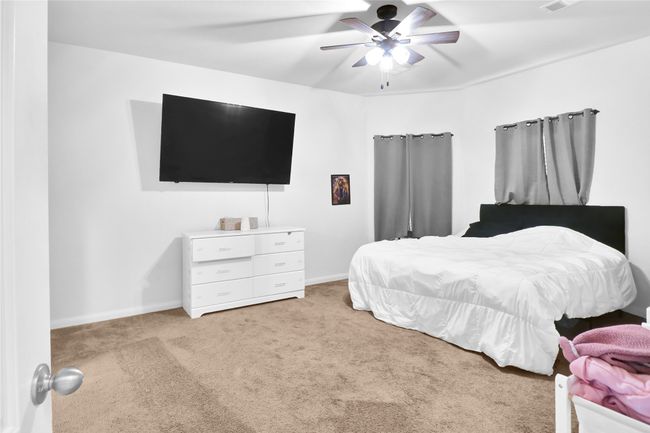 Bedroom featuring ceiling fan, baseboards, and carpet floors | Image 15