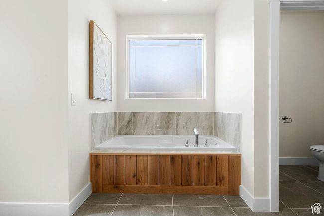 Full bathroom featuring tile patterned floors, a garden tub, baseboards, and toilet | Image 26