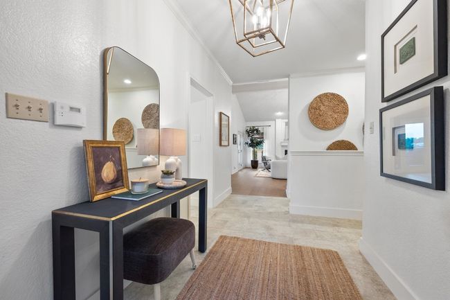 Corridor with ornamental molding and a chandelier | Image 6