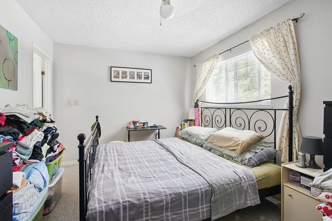 Bedroom featuring carpet flooring and a textured ceiling | Image 16