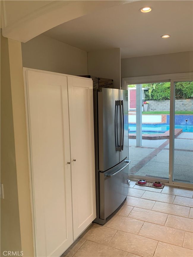 Kitchen pantry, frig & slider door to back patio | Image 10