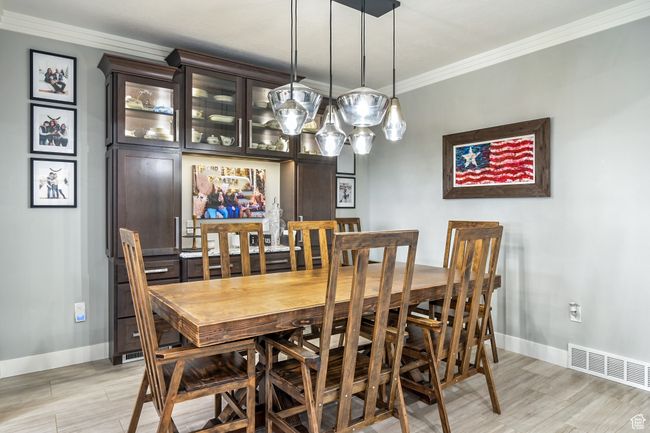Dining area featuring crown molding and light wood-type flooring | Image 22