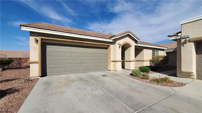 View of front of house featuring driveway, stucco siding, fence, an attached garage, and a tiled roof | Image 28