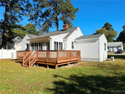 Rear view of house featuring a deck and a lawn | Image 3