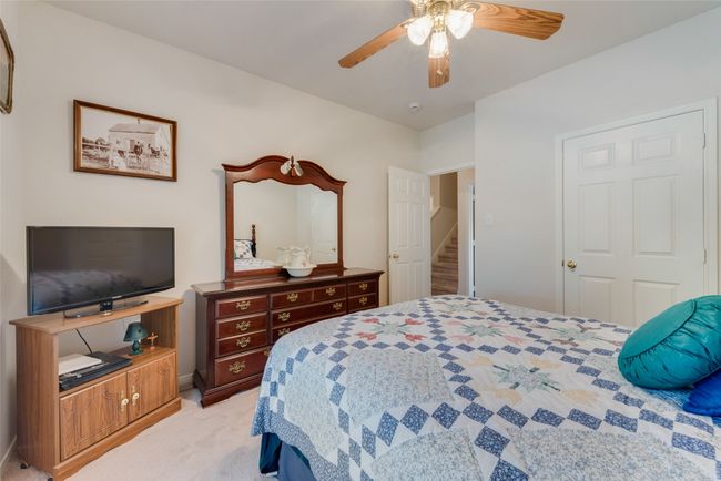 Bedroom with light carpet, ceiling fan, and baseboards | Image 28