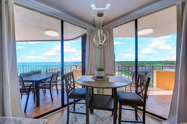 Dining area with a water view and hardwood / wood-style flooring | Image 13