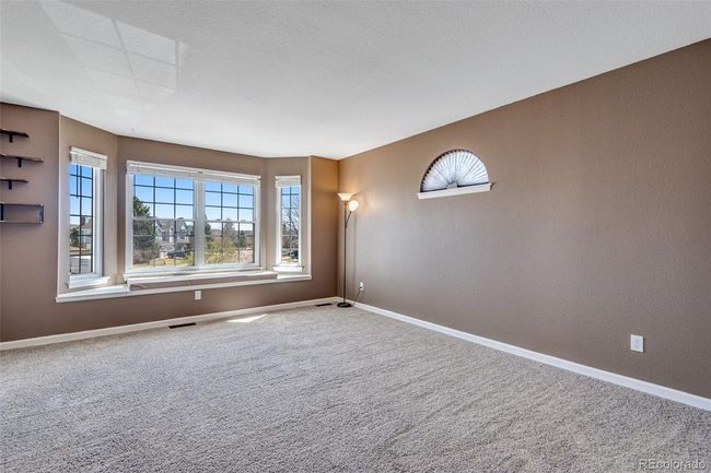 Spare room with a textured wall, carpet flooring, visible vents, and baseboards | Image 21