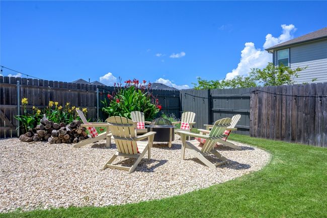 Fenced backyard featuring a fire pit | Image 19