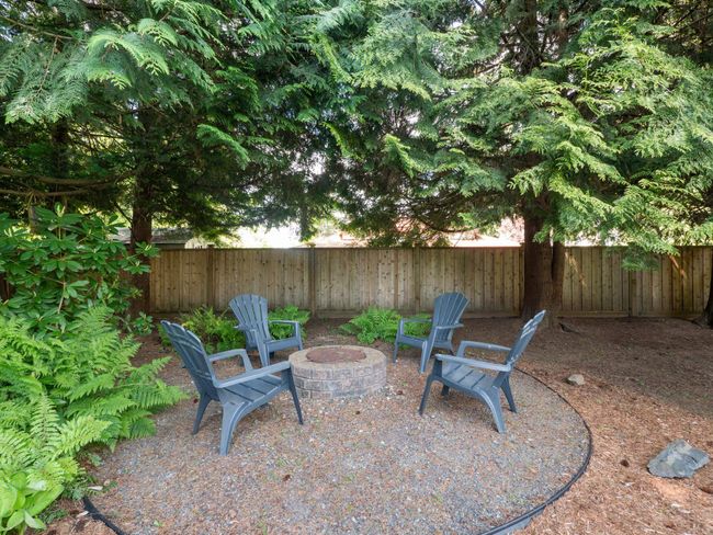 View of patio featuring a fenced backyard and an outdoor fire pit | Image 36