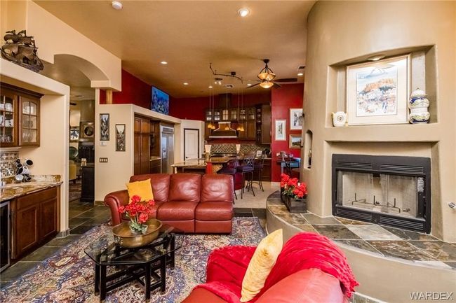 Living area with ceiling fan, a fireplace, recessed lighting, and arched walkways | Image 58