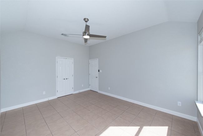 Primary bedroom facing towards front of house now, double doors in middle lead to primary bath | Image 12