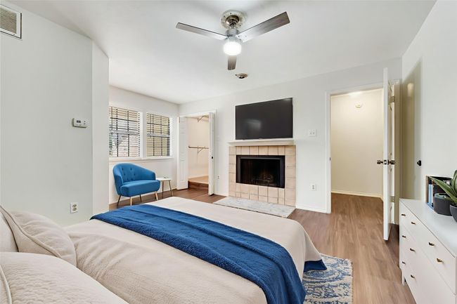 Virtually Staged bedroom with light wood finished floors, ceiling fan, and a tiled fireplace | Image 16