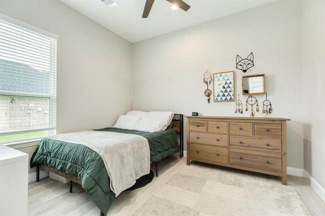 Secondary bedroom features awindow and ceiling fan. | Image 25