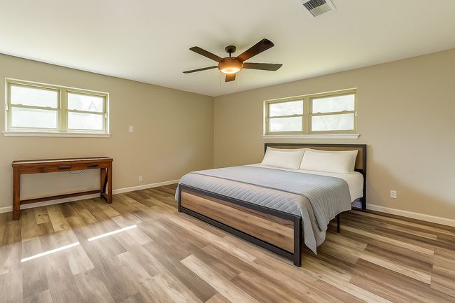 Bedroom featuring light wood finished floors and ceiling fan | Image 19