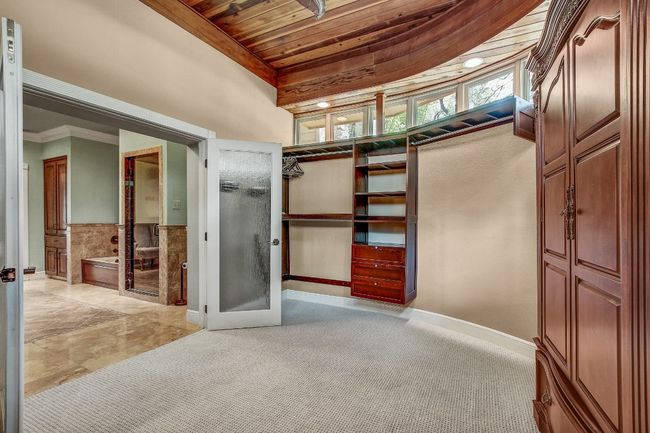 Unique walk in primary closet with cedar ceiling | Image 22