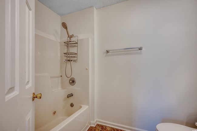 Bathroom with toilet and bathtub / shower combination | Image 27