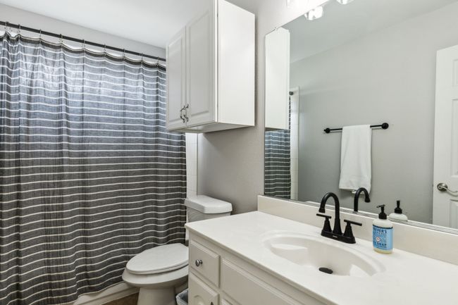 Full bath featuring vanity, curtained shower, and toilet | Image 23